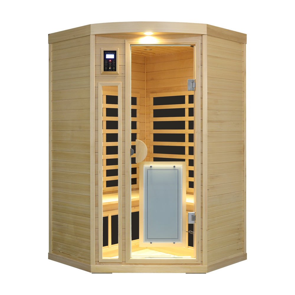 Hemlock Pentagonal Indoor Far Infrared Sauna Room with its overhead light on and front door open.