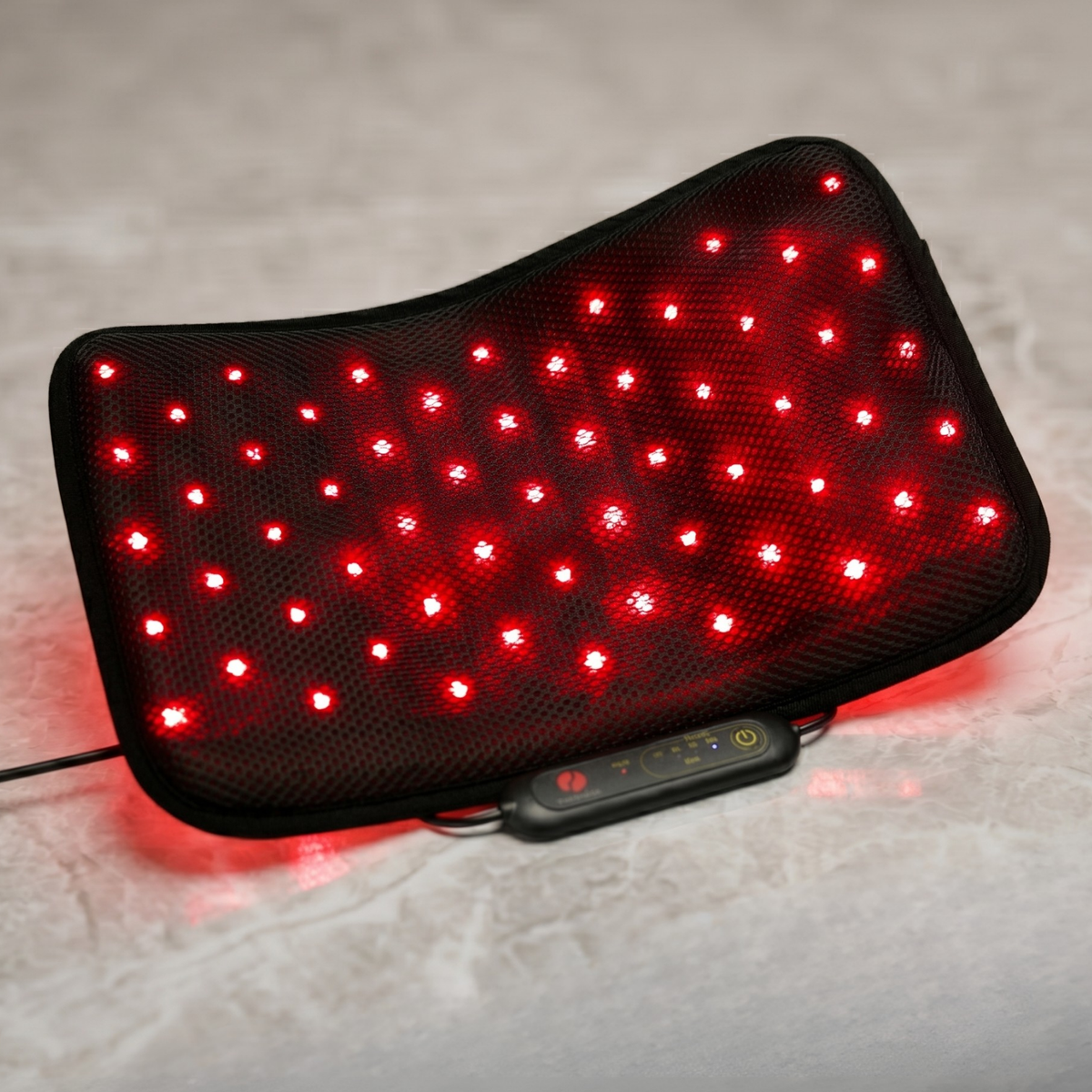 Therasage Tri-Lite™ Red Light Therapy Panel is bent into a curved shape on a stone surface, with its red lights on.