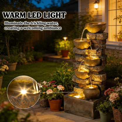 Resin Stacked Stone Bowl Cascade Fountain 28 Inch glowing at night in a flower garden, with a close-up inset.