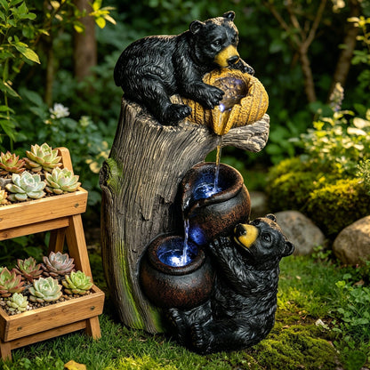Resin Black Bear Outdoor Water Fountain beside a wooden succulent stand in a leafy garden.