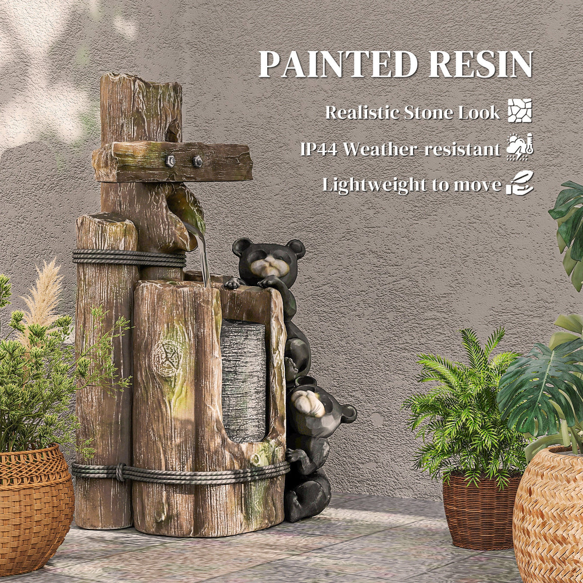 Resin Bear Fountain Two Cubs on Timber Post displayed between potted plants against a textured wall.