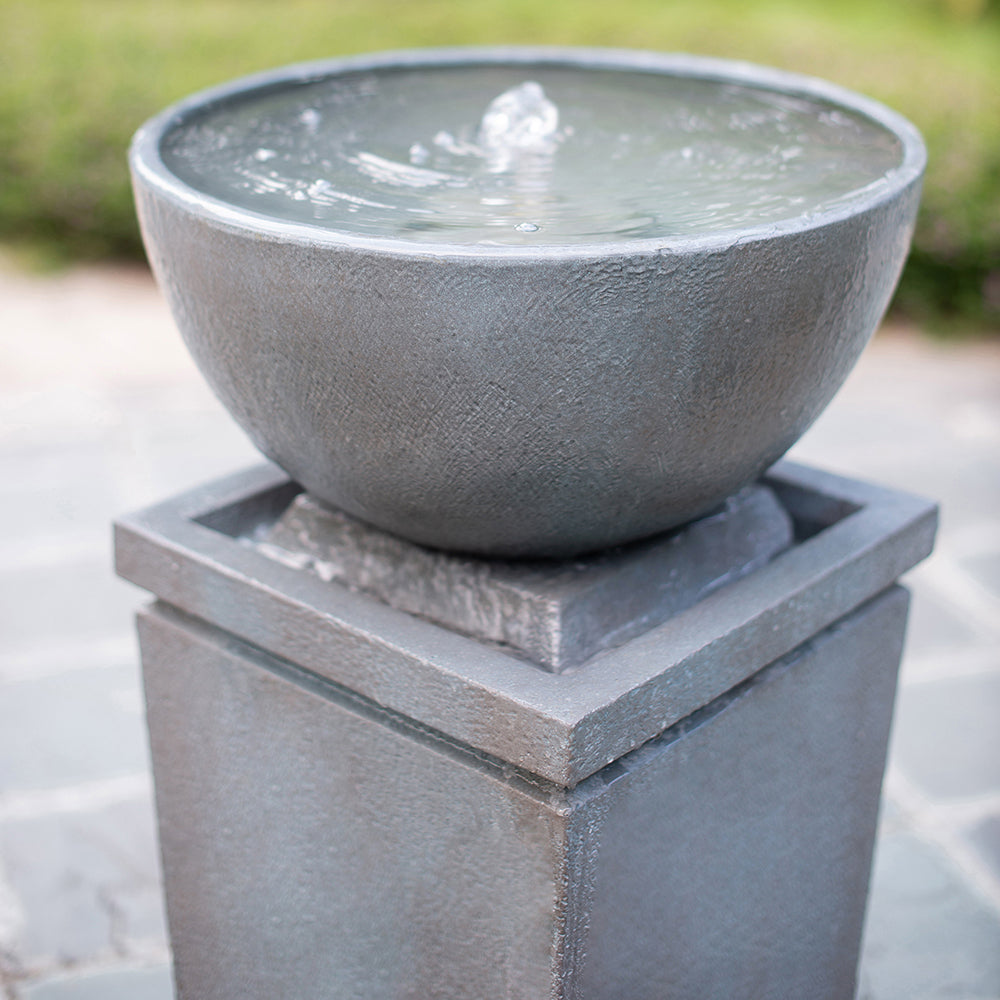 Resin Zen Bowl Pedestal Outdoor Fountain 44 Inch shown close up, with water bubbling in its bowl.