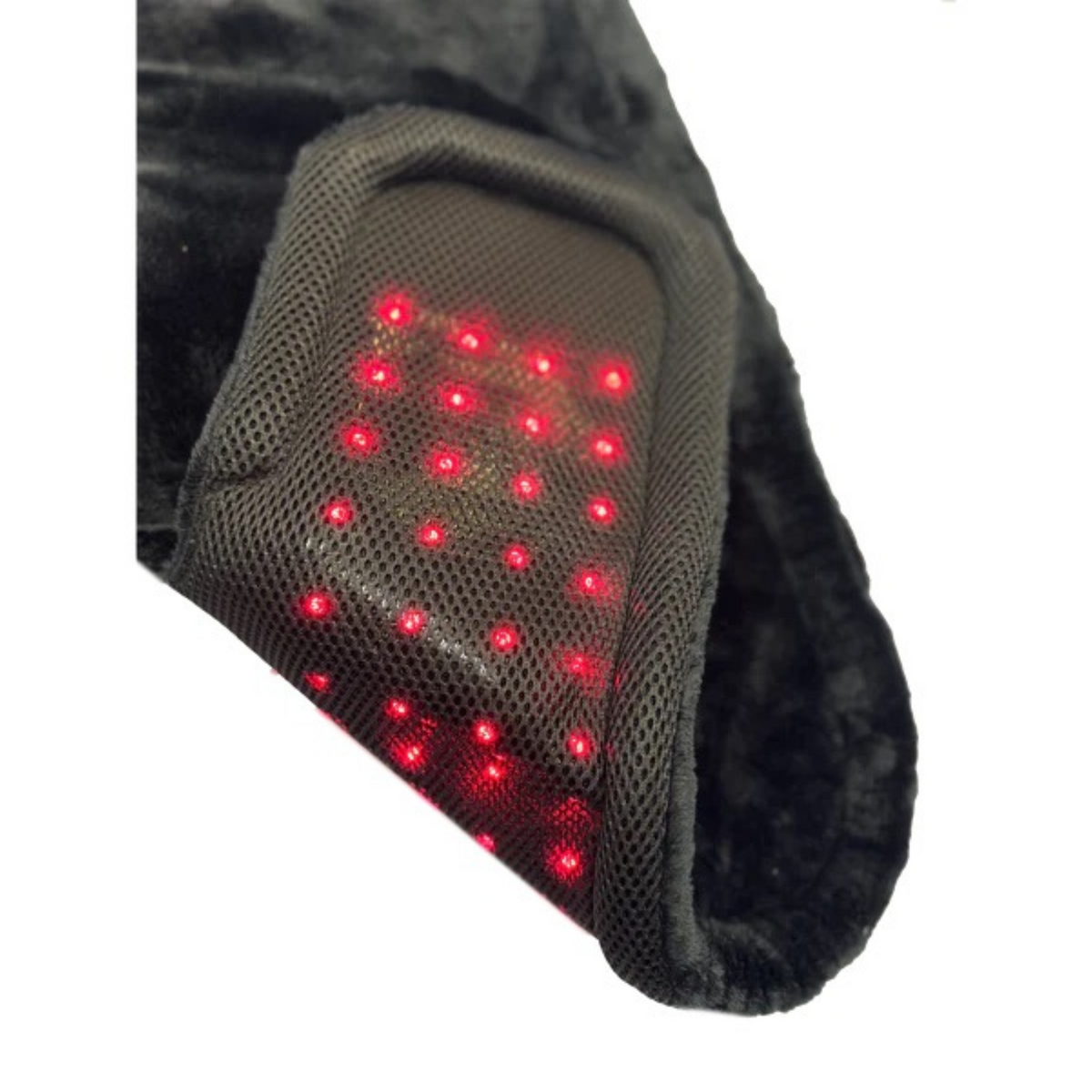 Close-up of the TheraPerfect Pad™ showing glowing red lights beneath its dark mesh surface.