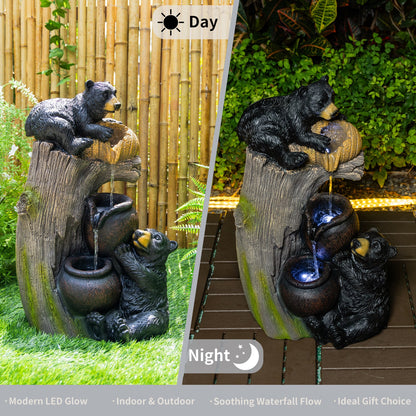 Resin Black Bear Outdoor Water Fountain shown in daylight and at night among garden greenery.