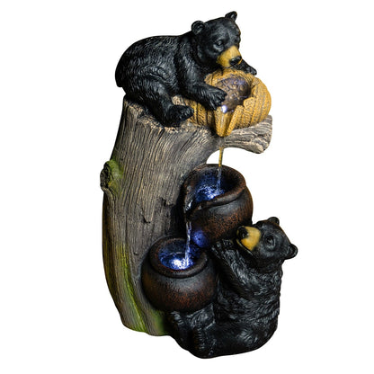 Resin Black Bear Outdoor Water Fountain on a white background, with two bears beside a stump and cascading bowls.