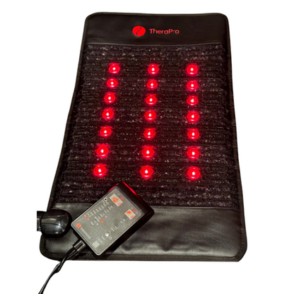 TheraPro™ PEMF pad laid flat with illuminated red circles and a wired controller on a white background.
