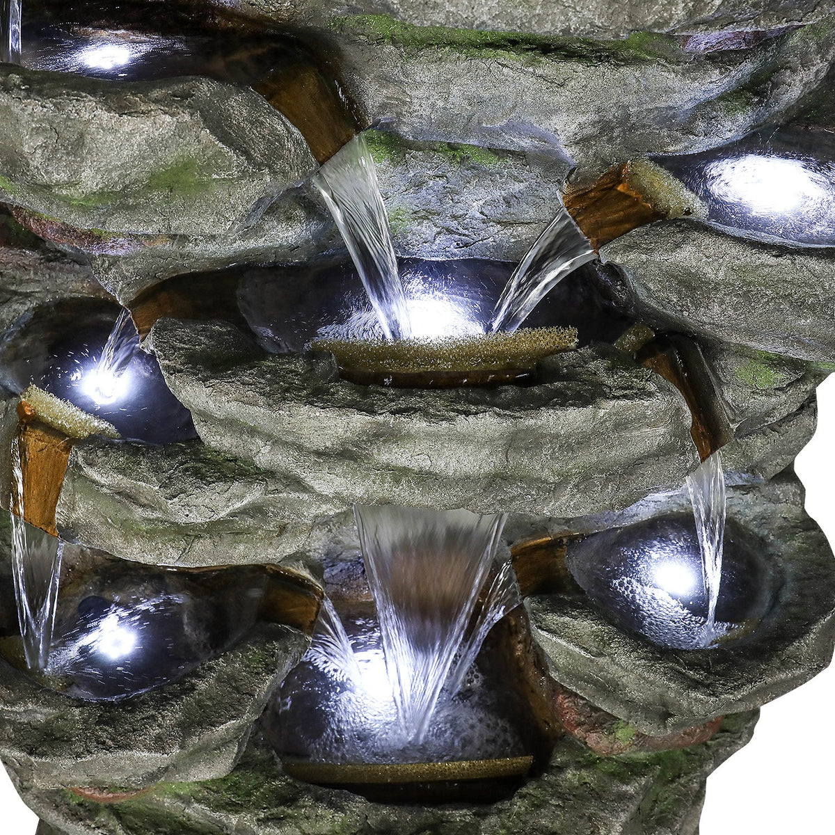 Resin Cliffside Rock Large Outdoor Water Fountain close-up of water spilling between rock-shaped basins with bright lights.