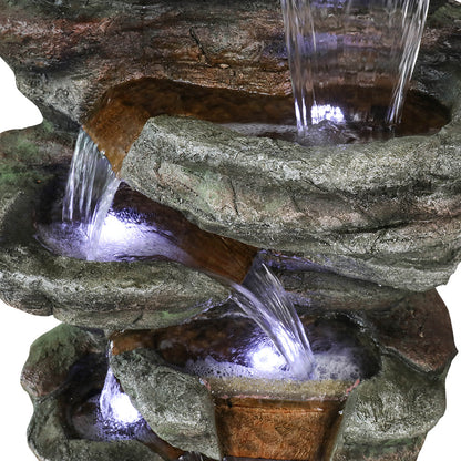 Close view of the Resin Serpentine Slate Column Cascading Outdoor Fountain, showing water spilling over textured ledges.