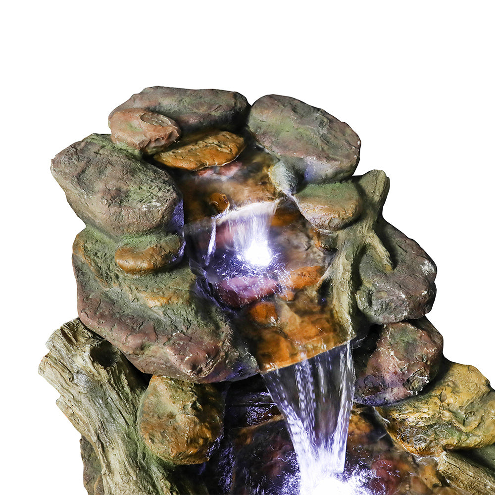 Resin Driftwood Creek Horizontal Outdoor Fountain 39 in close-up of upper rock tiers, glowing water, and a falling stream.