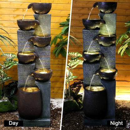 Resin 6 Tier Outdoor Water Fountain Pottery Bowls 53 in shown in side-by-side daytime and nighttime views.