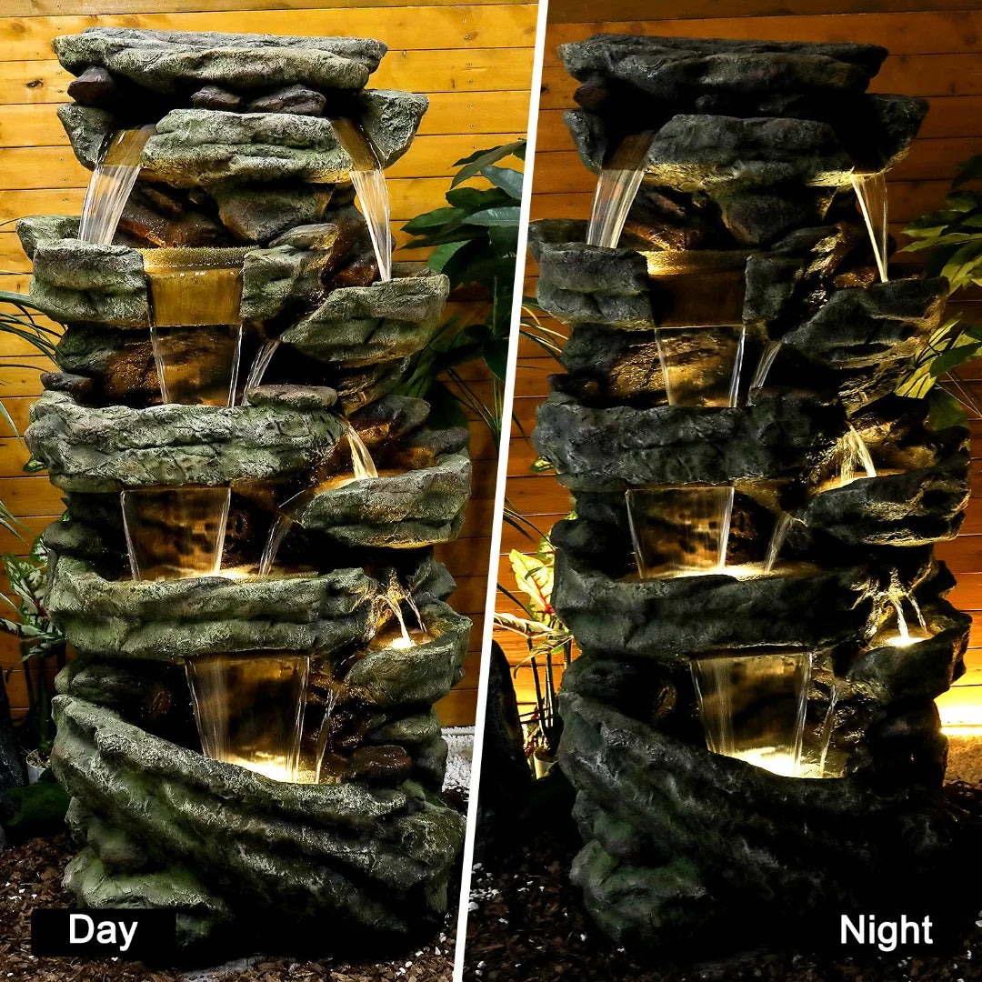 Resin Stacked Stone Rock Waterfall Outdoor Fountain shown in daylight and at night, with its basins glowing after dark.