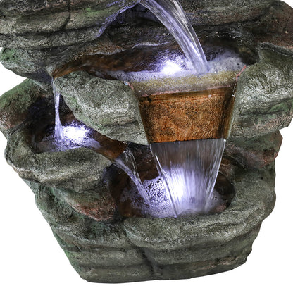 Macro view of the Resin Serpentine Slate Column Cascading Outdoor Fountain highlighting illuminated water streams.