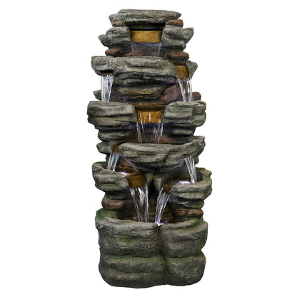 Resin Stepped Shale Outdoor Rock Fountain shown alone, with water flowing down its stacked rocky tiers.