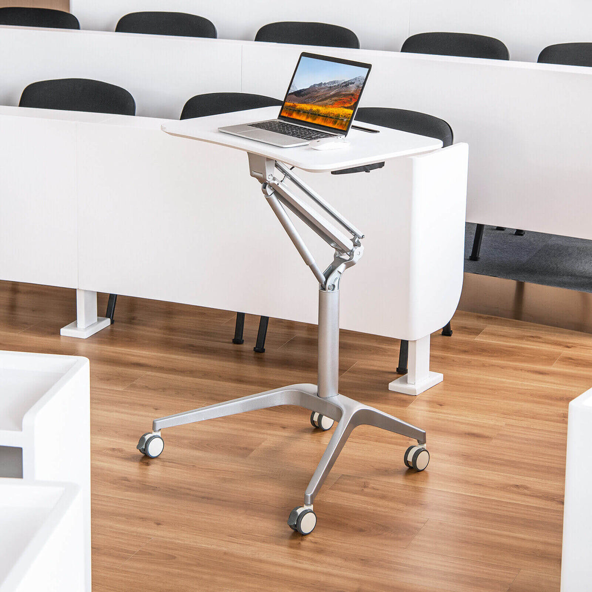 Laptop on an adjustable wheeled lectern in a classroom; Blast Pro Series 12000 BTU 20 SEER2 208 is not visible.