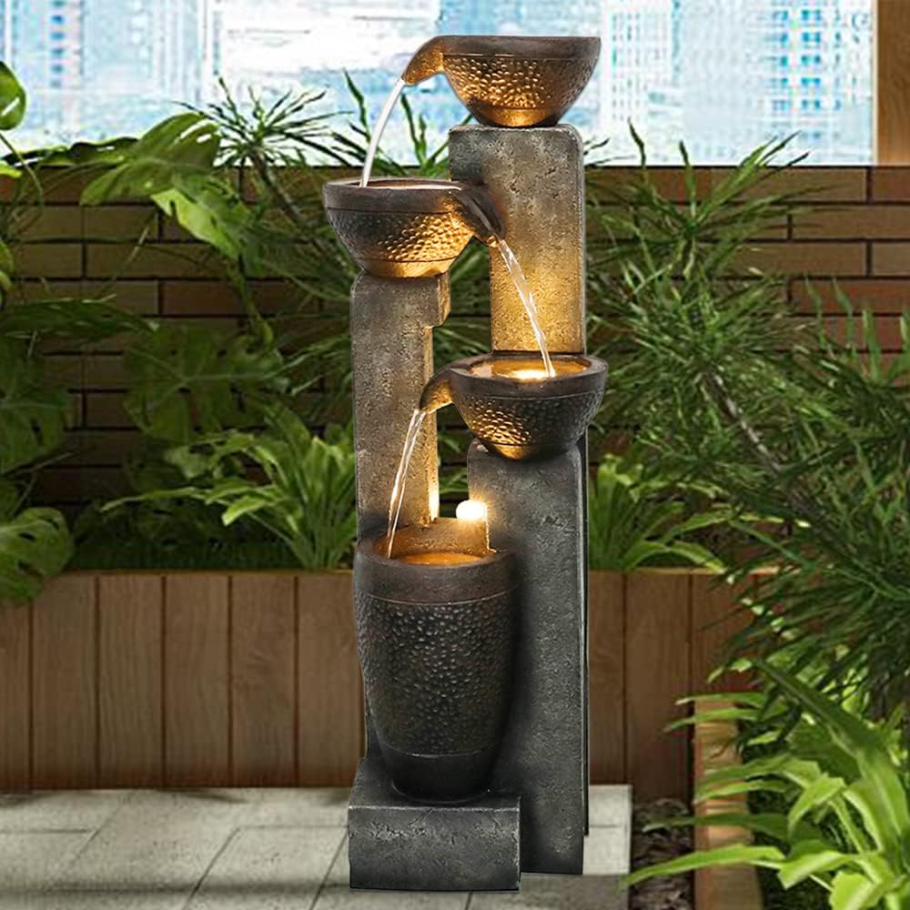 Resin Stacked Clay Pot Outdoor Water Fountain 40 Inch on a patio in front of a brick planter and greenery.