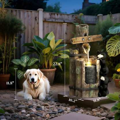 Resin Bear Fountain Two Cubs on Timber Post beside a seated dog in a pebble garden, with measurement lines.