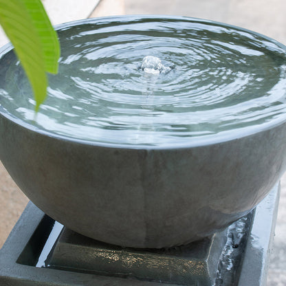 Close view of bubbling water in the bowl of the Resin Zen Bowl Pedestal Outdoor Fountain 44 Inch.