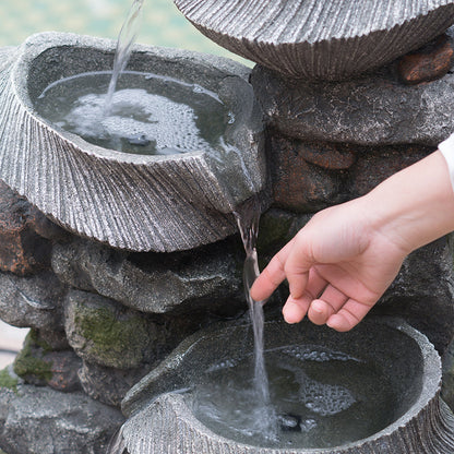Person touching water on the Resin Fluted Basin Tiered Outdoor Water Fountain 650 GPH.