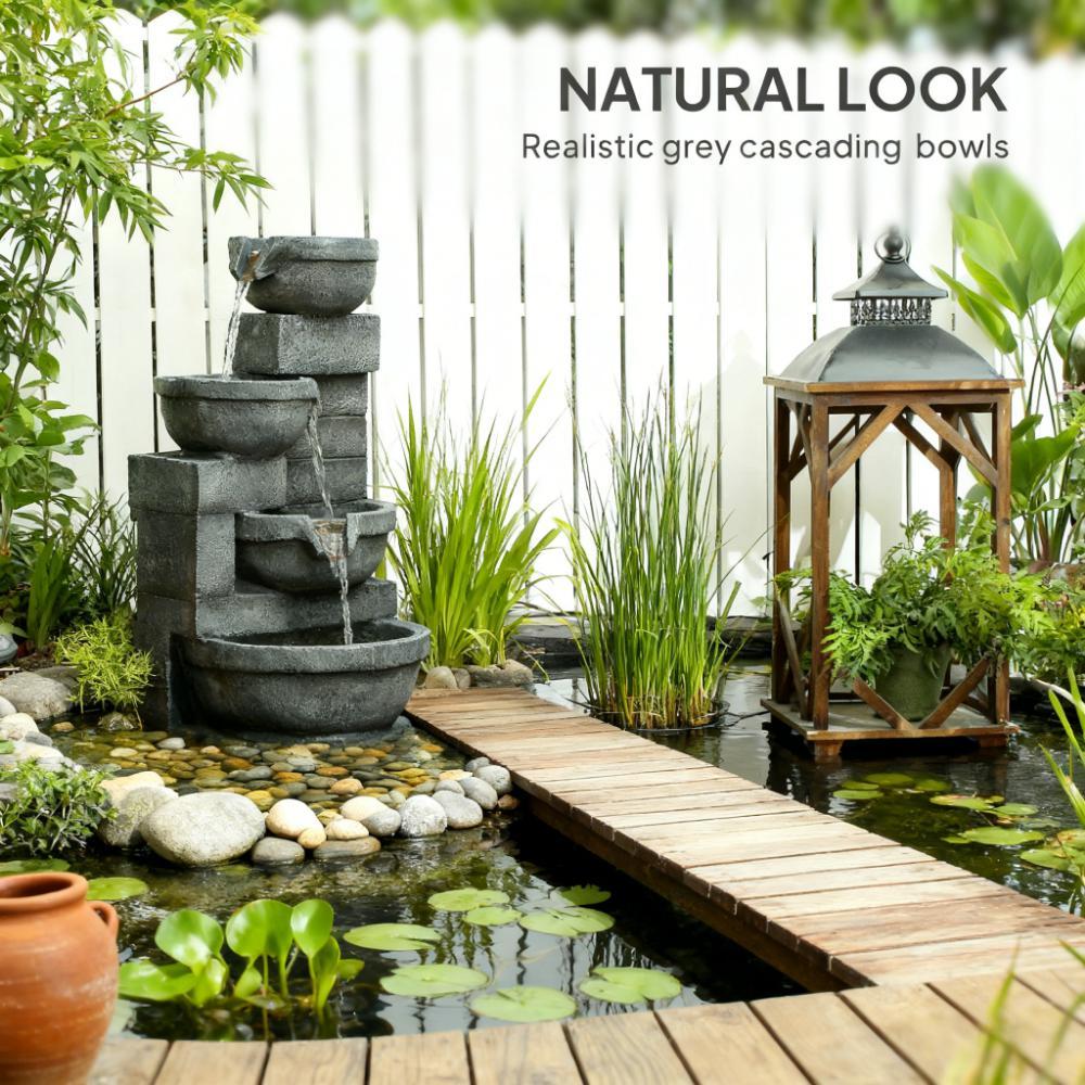 Resin Offset Bowl Cascading Outdoor Water Fountain beside a wooden footbridge, pond plants, and a lantern.