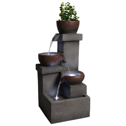 Resin Outdoor Fountain and Planter Stacked Stone shown isolated on a white background with flowing water and lit basins.