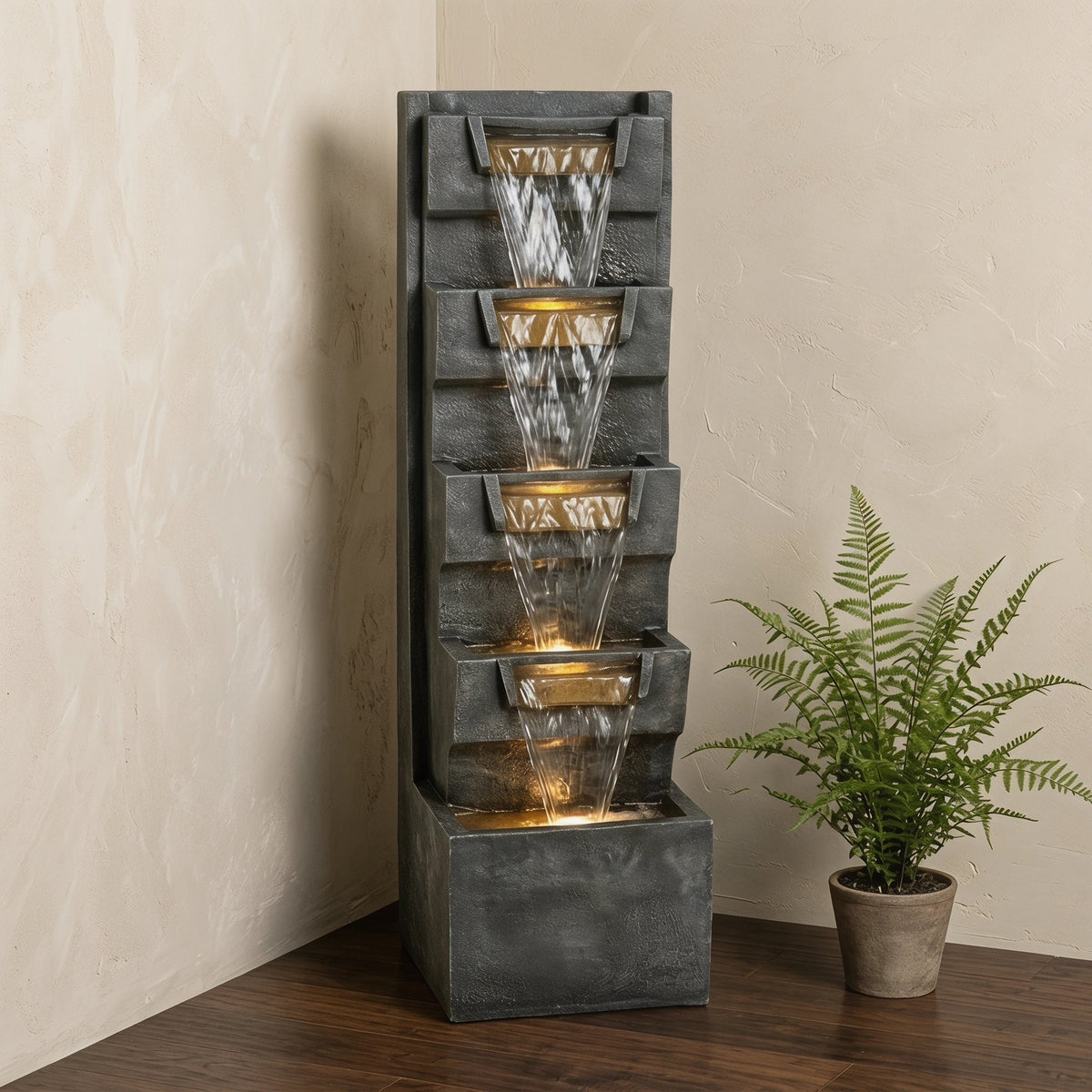 Resin Modern Outdoor Fountain 39 Inch Tilted Chutes stands beside a potted fern against a light wall.